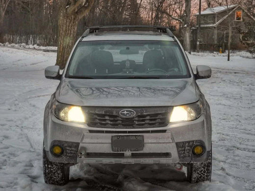 A car with Hawkglow LED headlights on a snowy road, highlighting LED vs Halogen Headlights and the benefits of car LED headlight bulbs for better visibility.